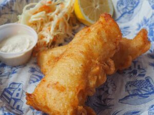 Image of fried cod fish pieces with coleslaw and tartar sauce