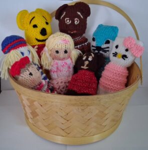 image of a basket containing knitted dolls by the CC Izzy Knitters